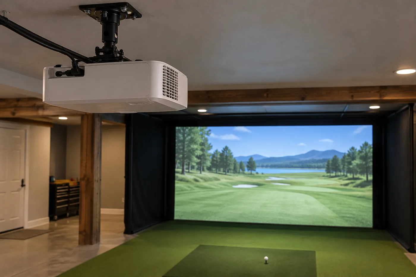 Projector mounted above a golf simulator screen and enclosure